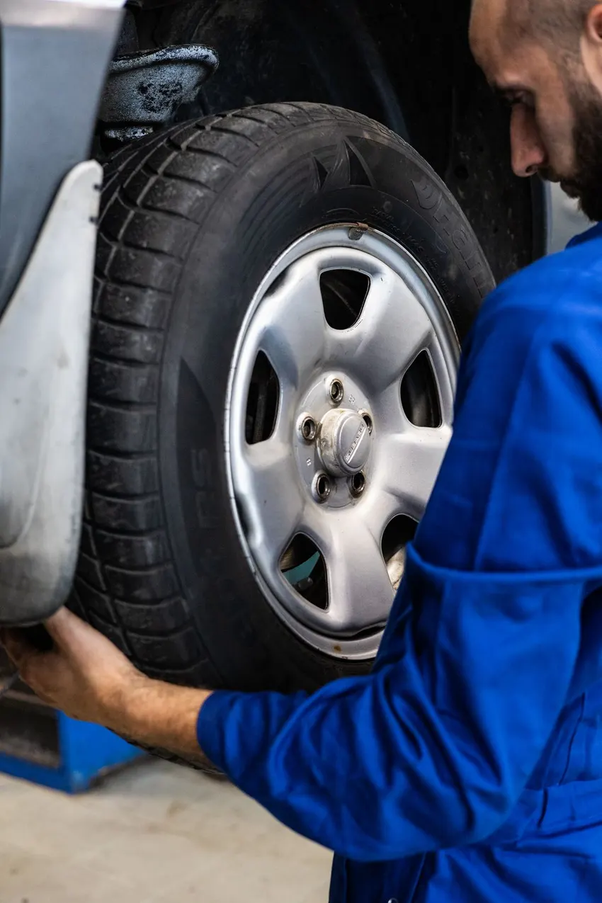 Technician working on a car wheel
